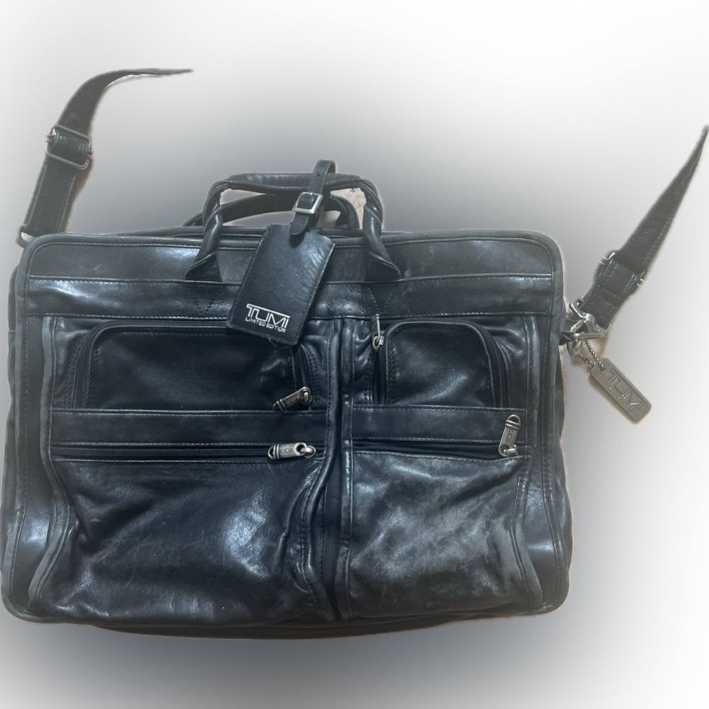 Tumi leather laptop briefcase. Chunky hardware, soft black quality leather.